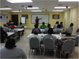 Henry Quesada teaches cost allocation to sugar cane farmers in Belize as part of the financial management training.